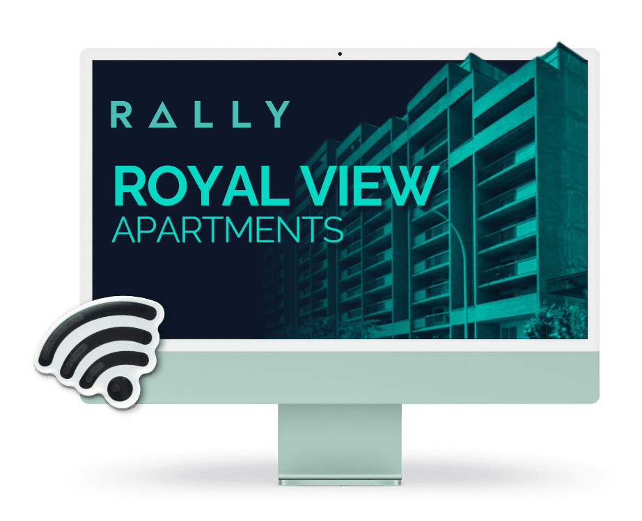 An iMac computer with a picture of a building the Rally logo and a Wi-Fi symbol appear prominently and the building name Royal View Apartments